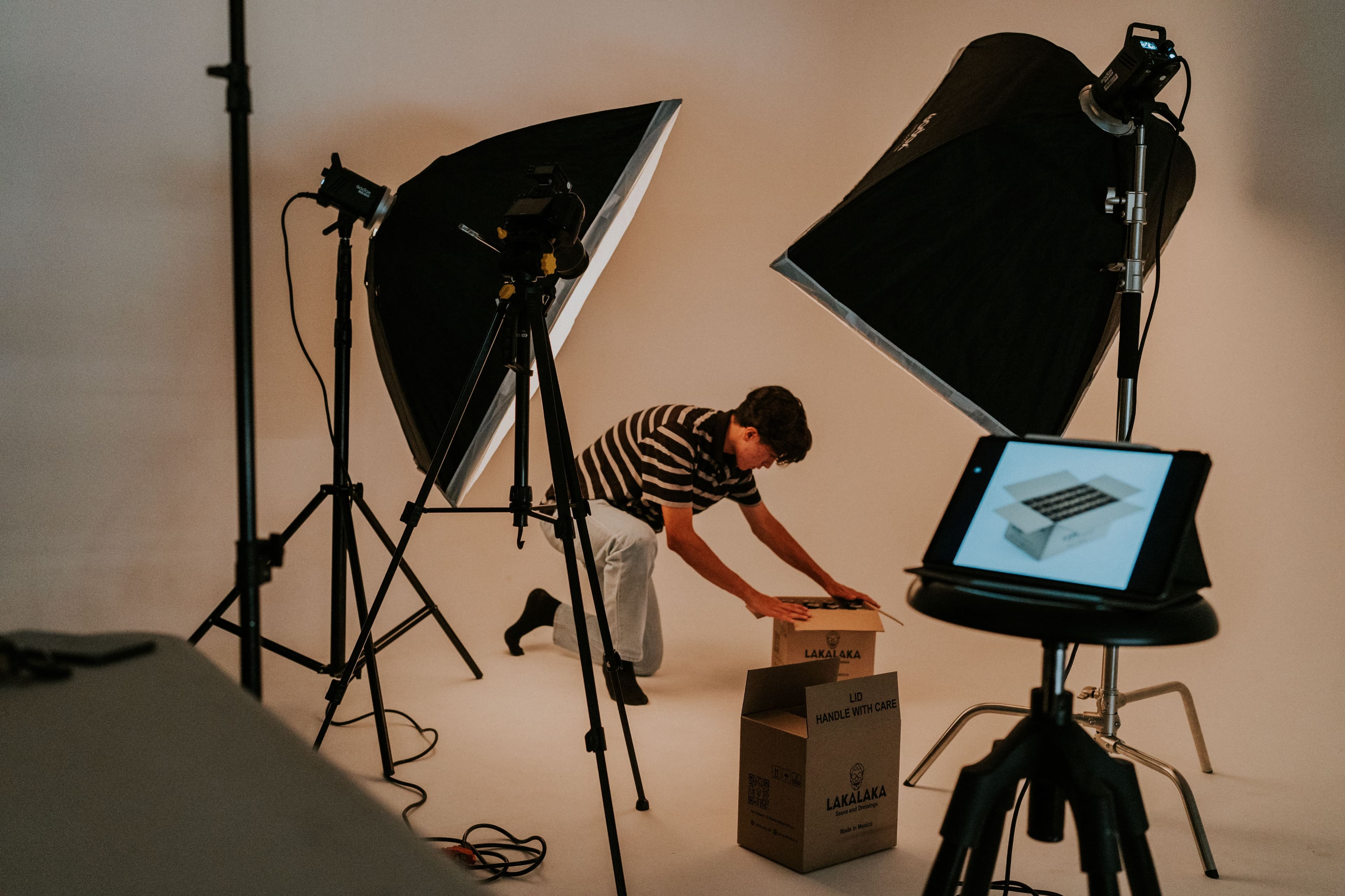 Studio photoshoot in progress with lighting, camera and product packing