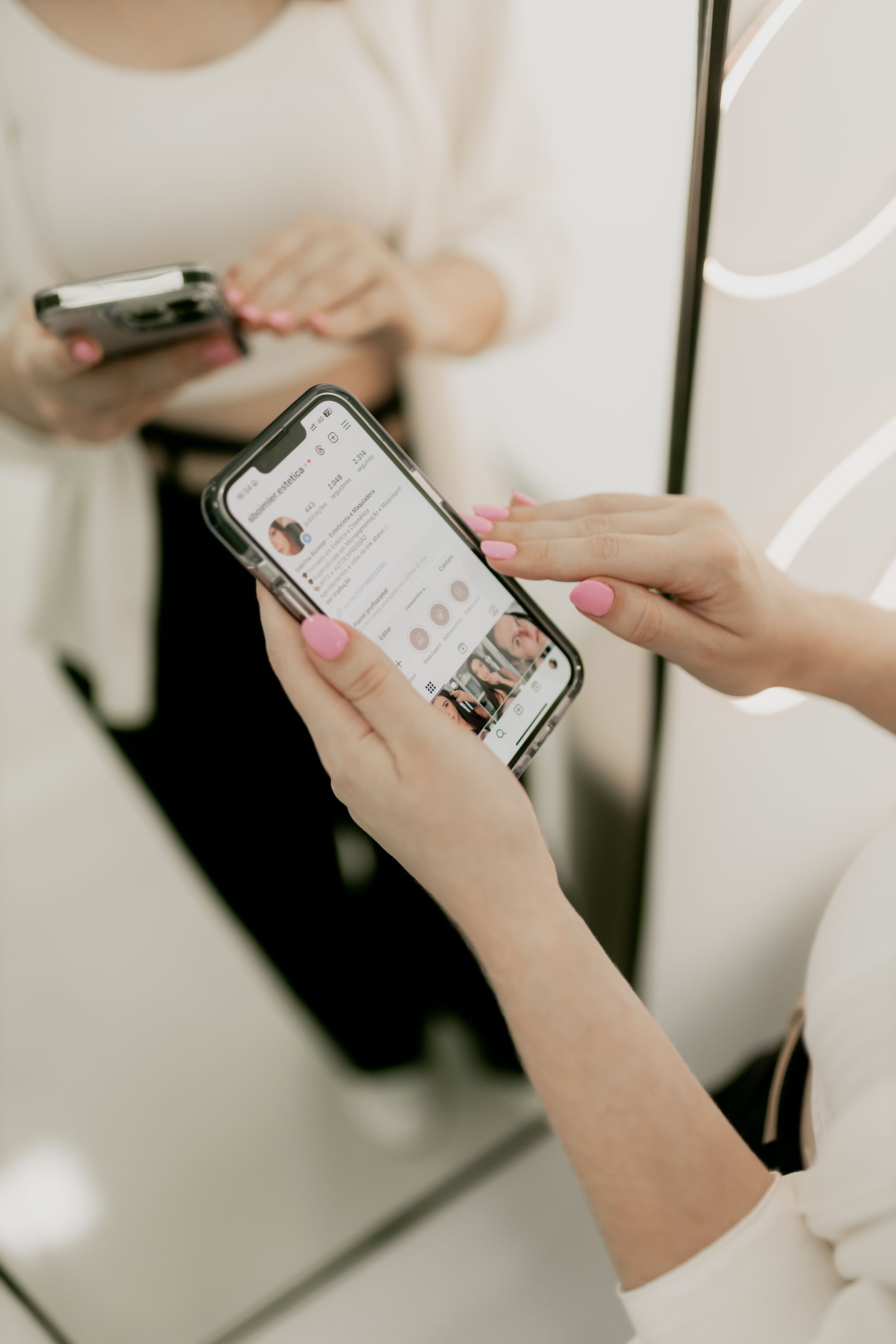 Hands holding a phone open on a social media profile